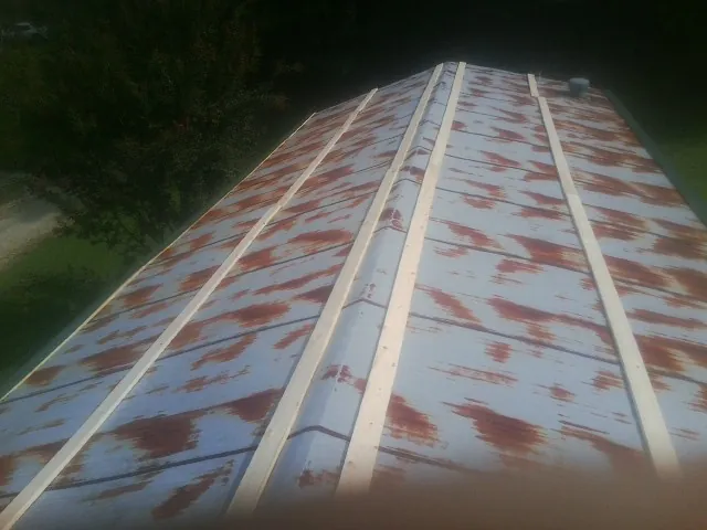 Rusted metal roof panels with new wood purlins before replacement — Storm Damage Roof Repair in Owensville by Roofing Brothers